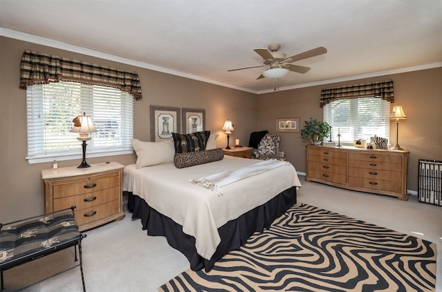 carpeted bedroom with ornamental molding and ceiling fan