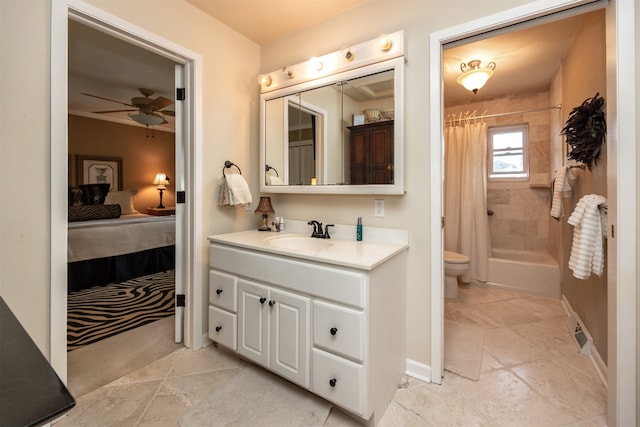 full bathroom featuring vanity, shower / bath combination with curtain, toilet, and ceiling fan