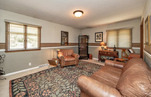 carpeted living room featuring a textured ceiling