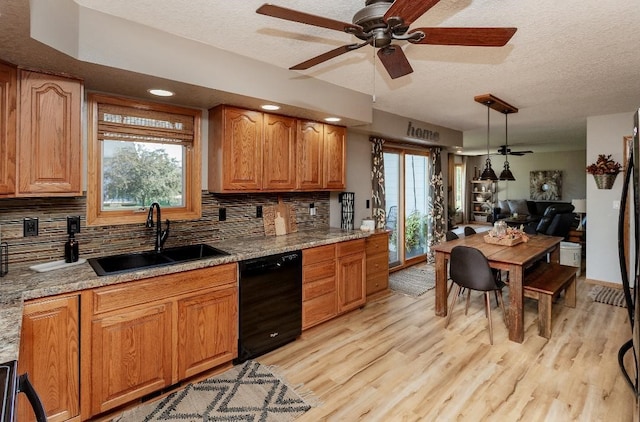 kitchen featuring light hardwood / wood-style floors, black dishwasher, sink, and plenty of natural light