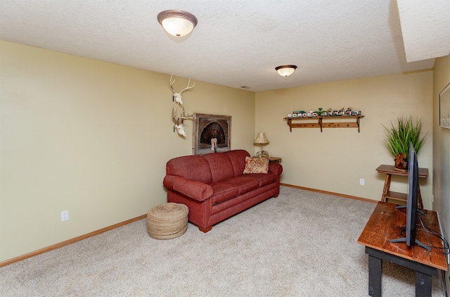 living room featuring carpet and a textured ceiling