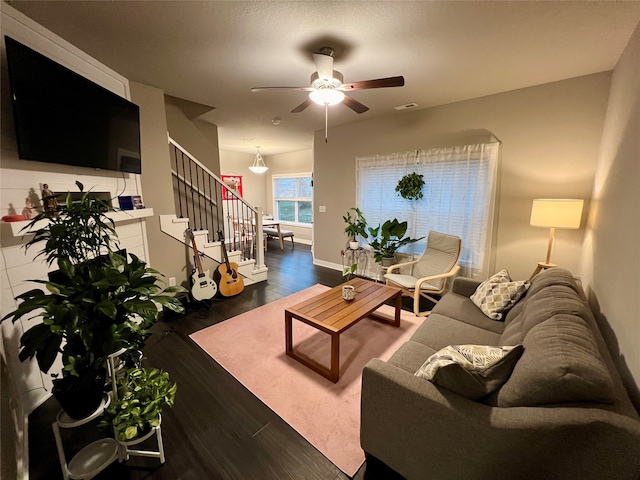 living room featuring dark hardwood / wood-style floors and ceiling fan