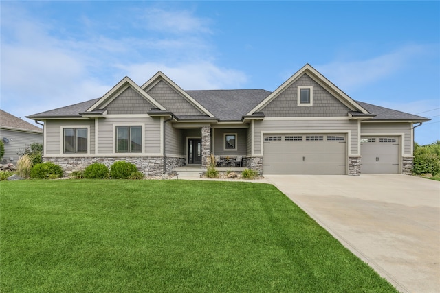 craftsman-style home featuring a front yard and a garage