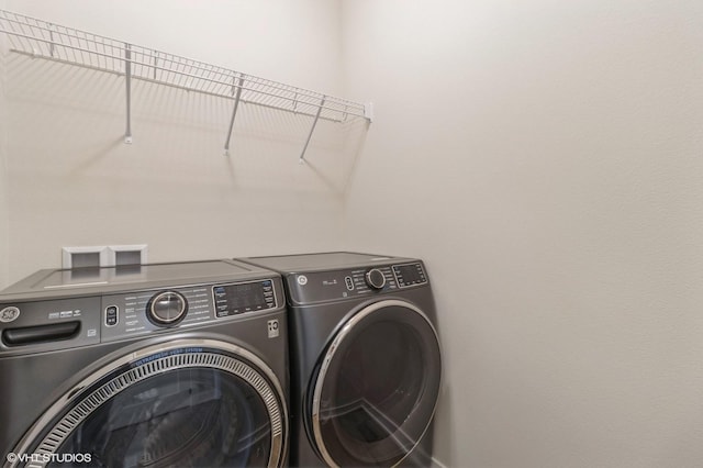 washroom featuring washer and clothes dryer