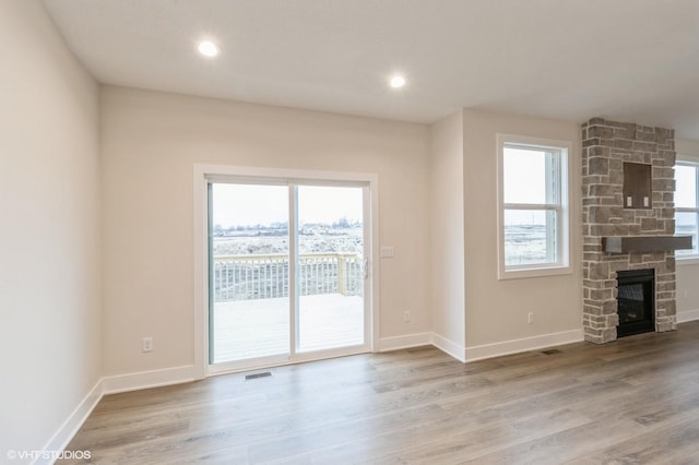 unfurnished living room with hardwood / wood-style flooring and a fireplace