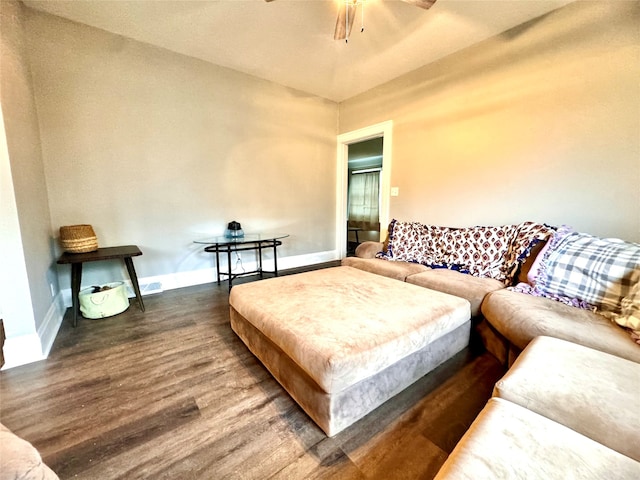 living room with ceiling fan and dark hardwood / wood-style flooring