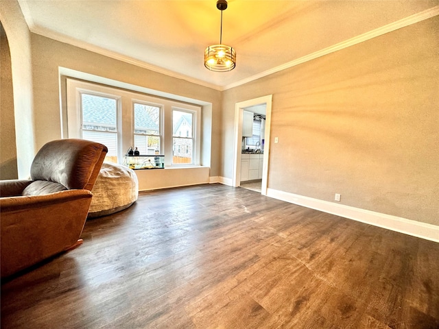 sitting room with crown molding and hardwood / wood-style flooring