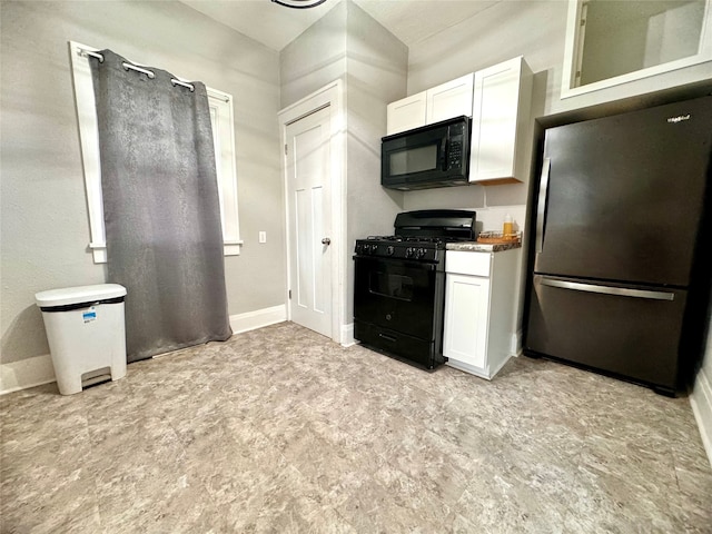 kitchen featuring black appliances and white cabinetry