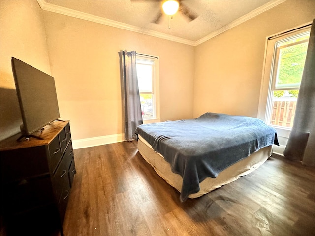 bedroom with dark hardwood / wood-style flooring, ornamental molding, and ceiling fan