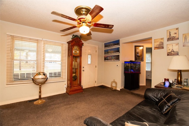 1600 Evergreen Ave, Des Moines, IA 50320 - living room featuring dark colored carpet, ceiling fan, and baseboards