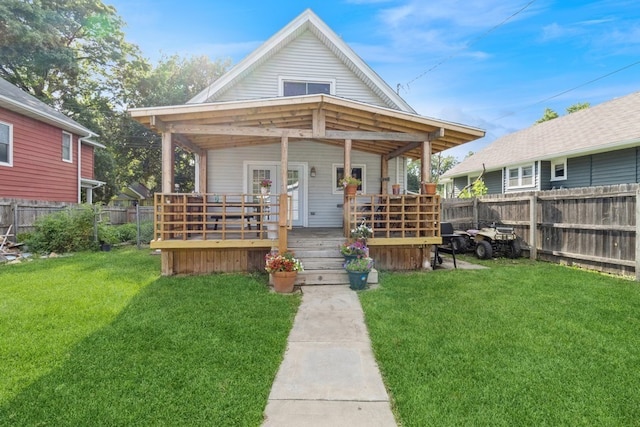 bungalow-style home with a front yard and a wooden deck