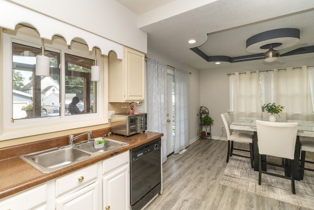 kitchen featuring black dishwasher, light hardwood / wood-style flooring, sink, and white cabinets