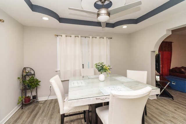 dining room with light hardwood / wood-style flooring and ceiling fan