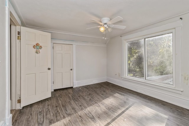 unfurnished bedroom with dark hardwood / wood-style flooring, vaulted ceiling, and ceiling fan