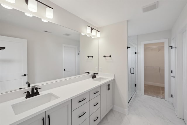 full bathroom with marble finish floor, a sink, visible vents, and a walk in closet