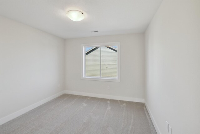 unfurnished room featuring carpet flooring and baseboards