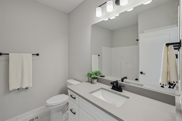 bathroom featuring a shower, vanity, and toilet