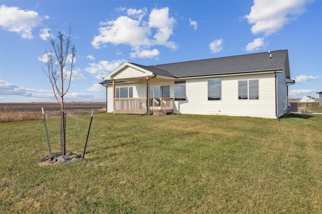 view of front of property featuring a front yard and a wooden deck