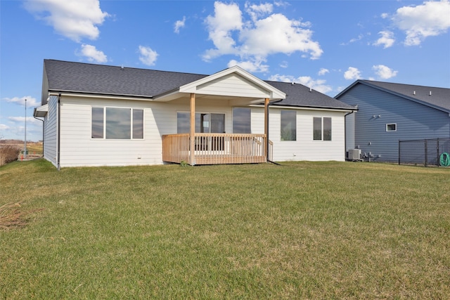 rear view of property with a lawn, a wooden deck, and central air condition unit