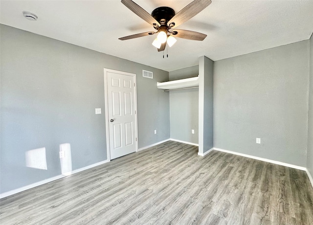 unfurnished bedroom featuring a closet, ceiling fan, and light hardwood / wood-style flooring