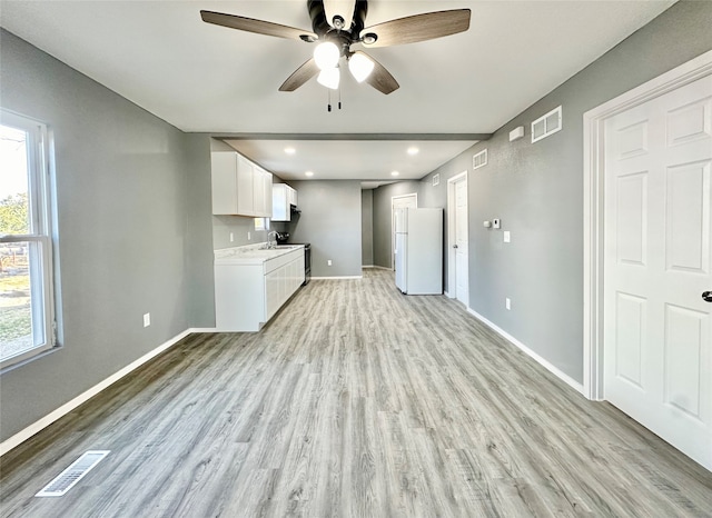 interior space with sink, light hardwood / wood-style flooring, and ceiling fan