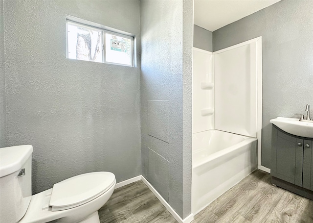 full bathroom featuring toilet, hardwood / wood-style flooring, vanity, and shower / bath combination