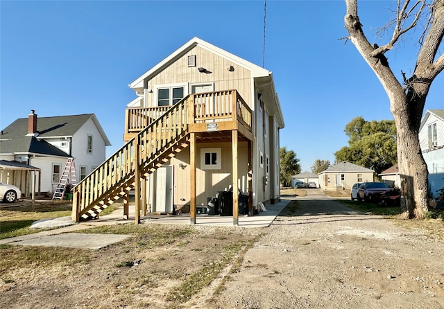 back of house featuring a wooden deck