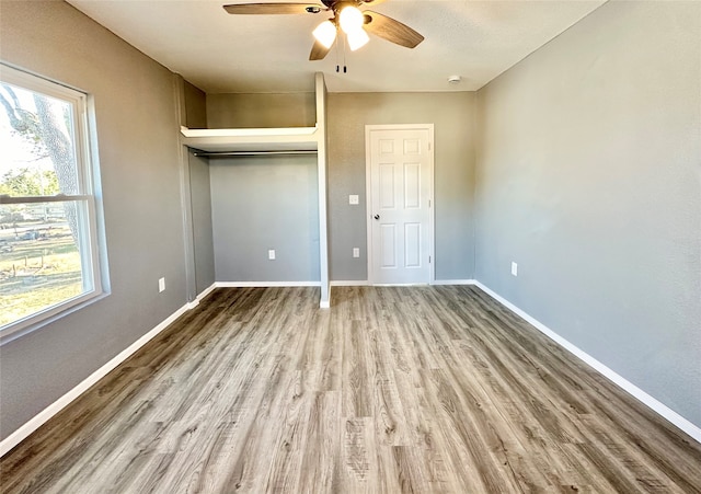 unfurnished bedroom featuring a closet, ceiling fan, and hardwood / wood-style floors