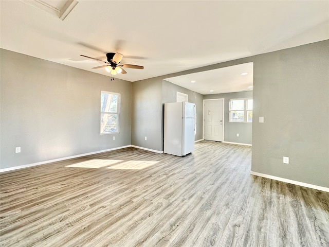 spare room featuring ceiling fan and light hardwood / wood-style flooring