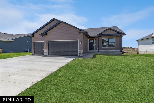 view of front of house with a front yard and a garage