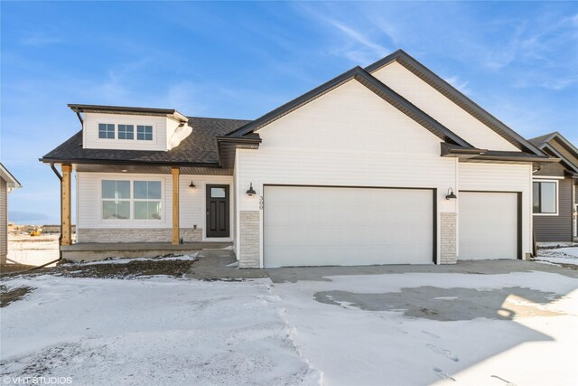 view of front of home featuring an attached garage and stone siding