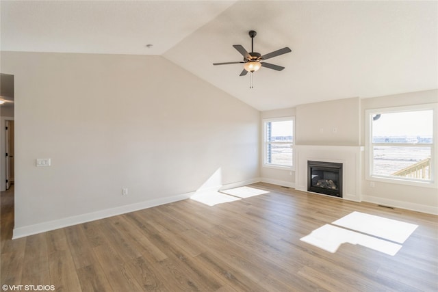 unfurnished living room featuring ceiling fan, lofted ceiling, and light hardwood / wood-style floors