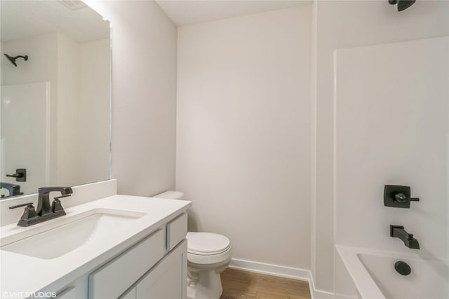 full bathroom with wood-type flooring, shower / washtub combination, vanity, and toilet