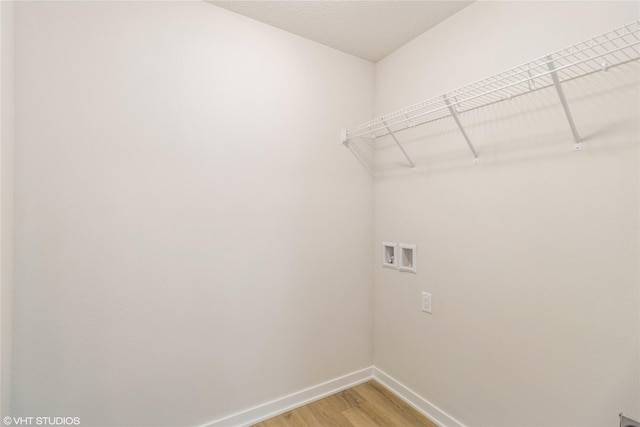 laundry room with hookup for a washing machine and hardwood / wood-style flooring