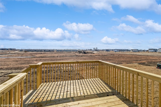 wooden deck with a rural view