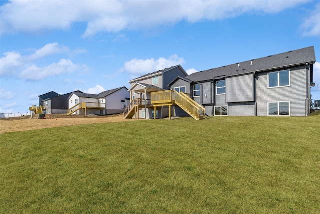 back of house with a deck and a lawn