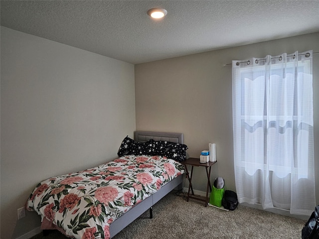 carpeted bedroom featuring a textured ceiling