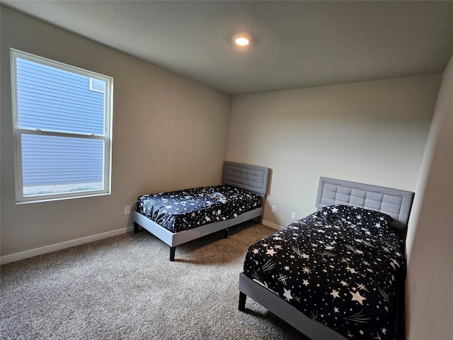 bedroom with carpet and multiple windows