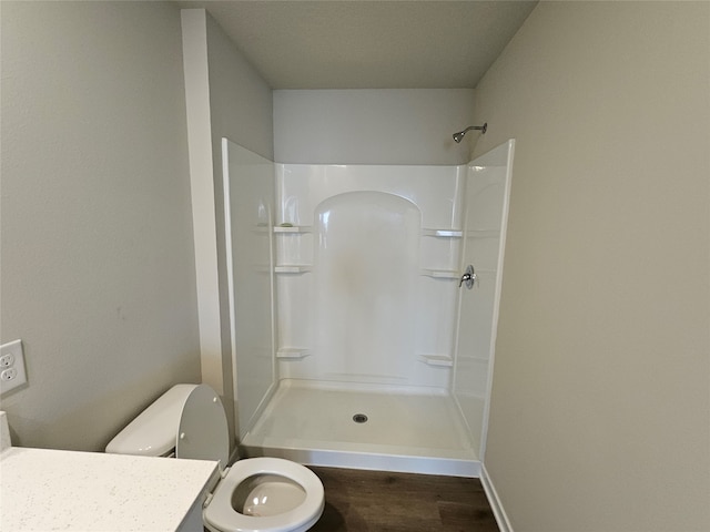 bathroom with vanity, hardwood / wood-style floors, toilet, and walk in shower