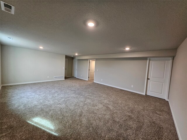 basement with carpet flooring and a textured ceiling