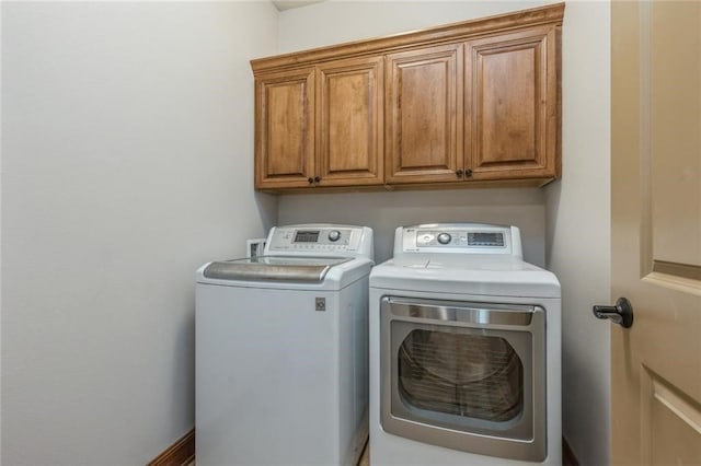 laundry room with cabinets and separate washer and dryer