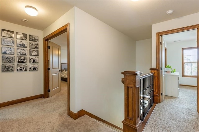 hall with light colored carpet