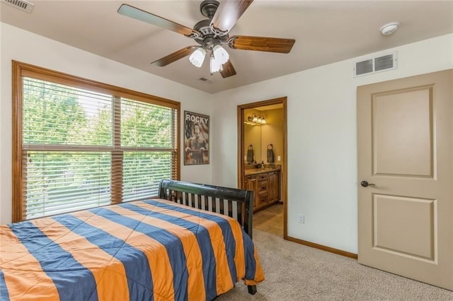 carpeted bedroom featuring ensuite bath and ceiling fan