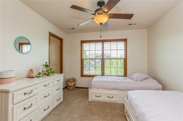 bedroom featuring light carpet and ceiling fan