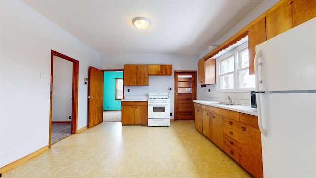 kitchen with decorative backsplash, white appliances, and sink