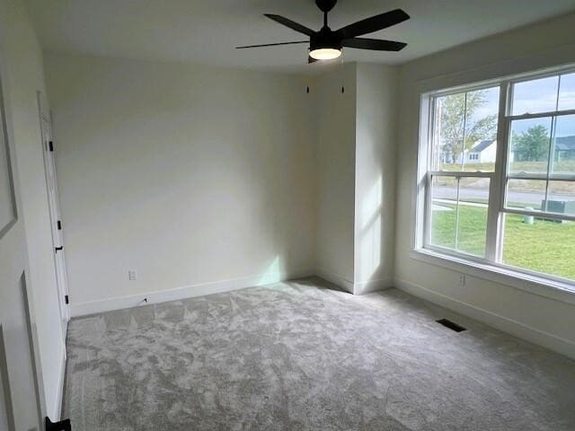 unfurnished room with ceiling fan and light carpet