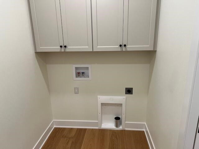 washroom featuring hookup for an electric dryer, dark hardwood / wood-style flooring, cabinets, and hookup for a washing machine