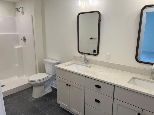 bathroom with a shower, tile patterned floors, vanity, and toilet