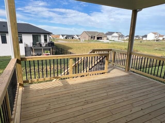 wooden deck with a lawn