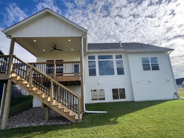 back of house with ceiling fan and a yard